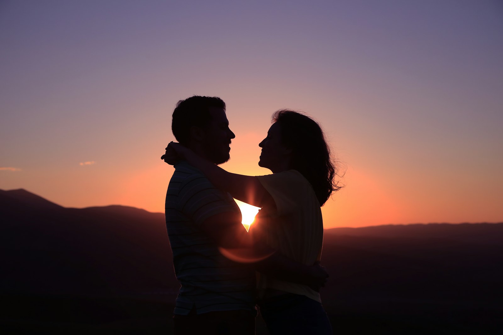 Couple embracing at sunset — rekindling their connection