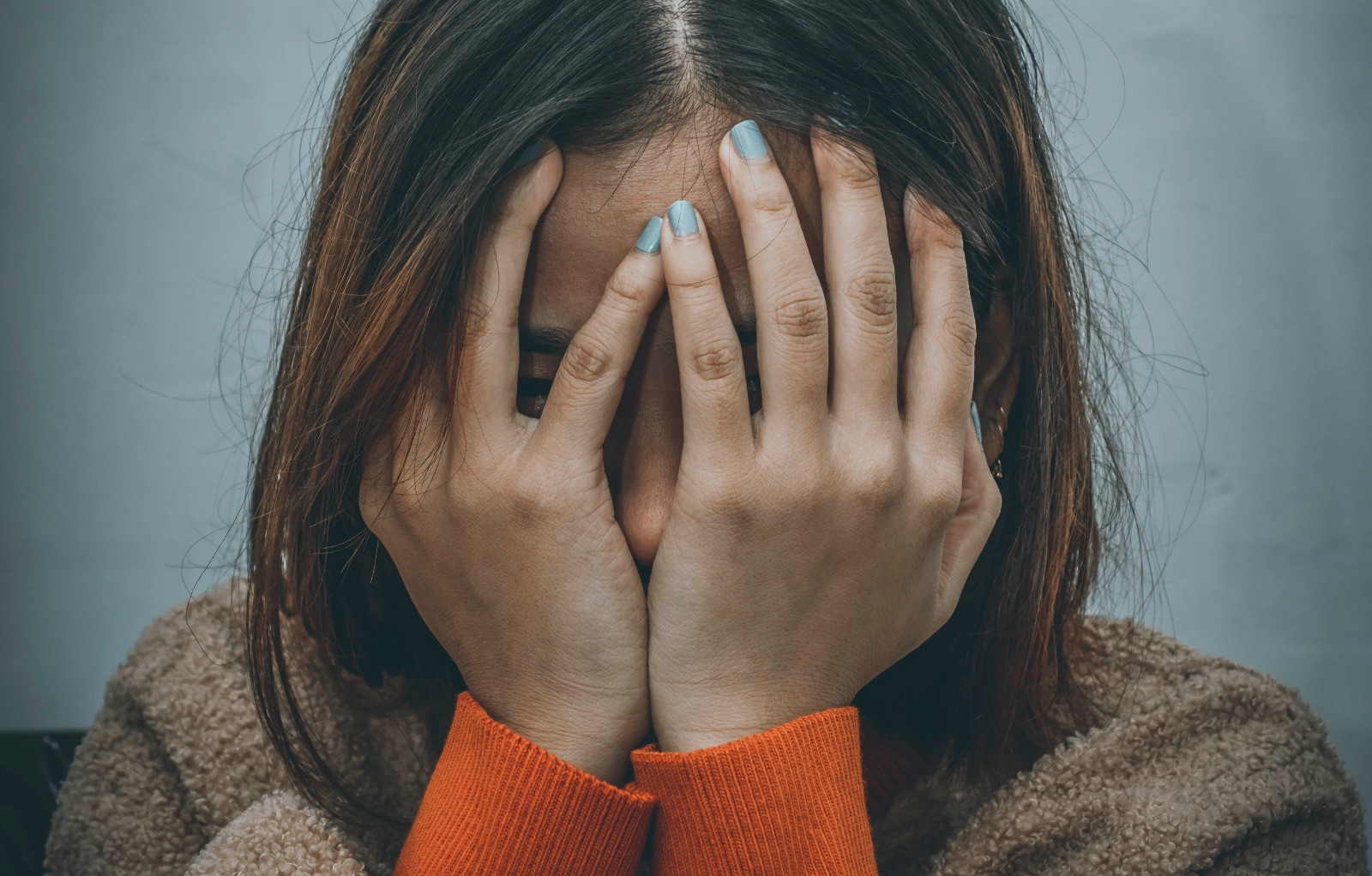 Woman hands on face feeling guilty about her divorce