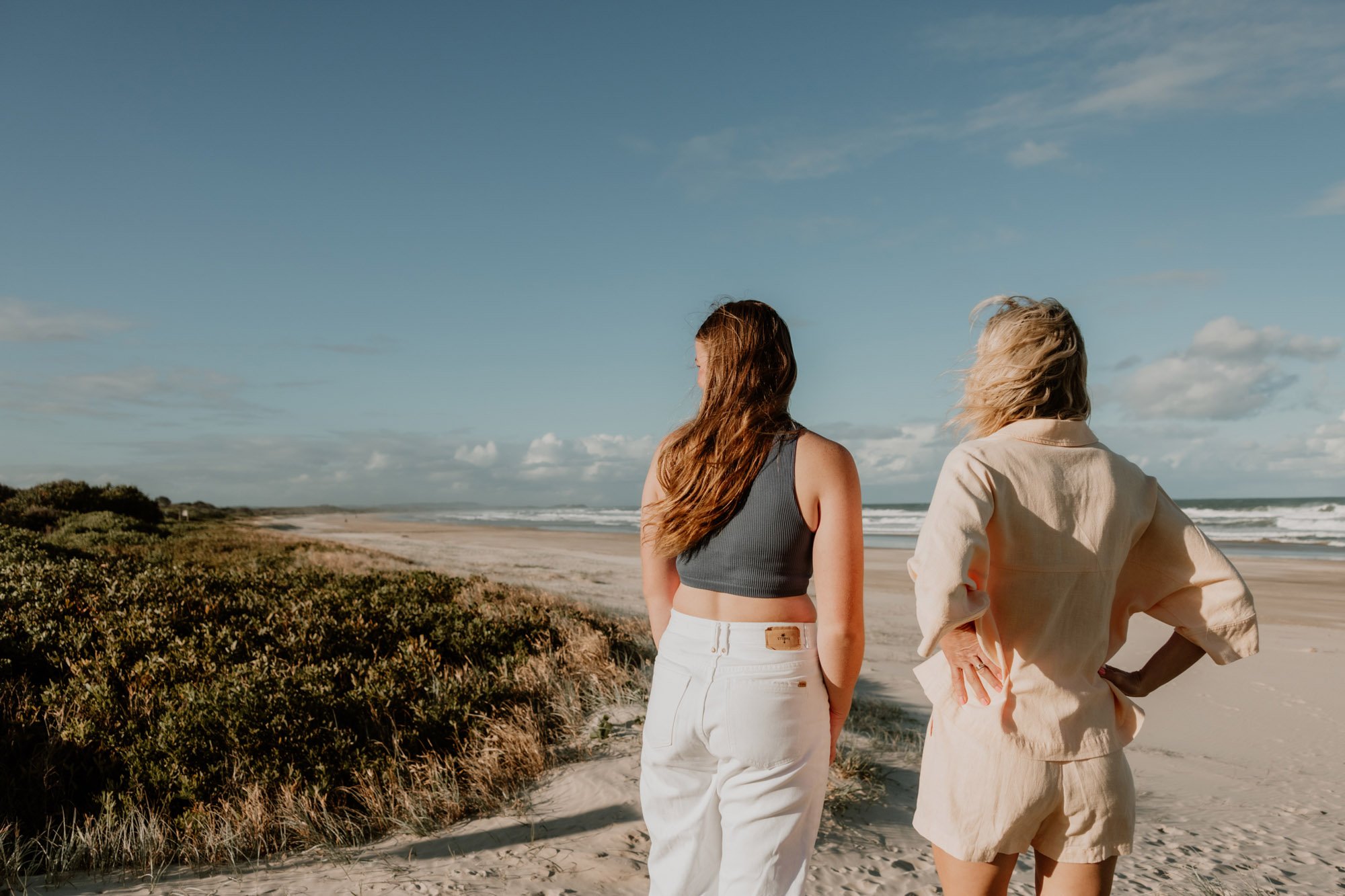 Two women walking along a beautiful beach