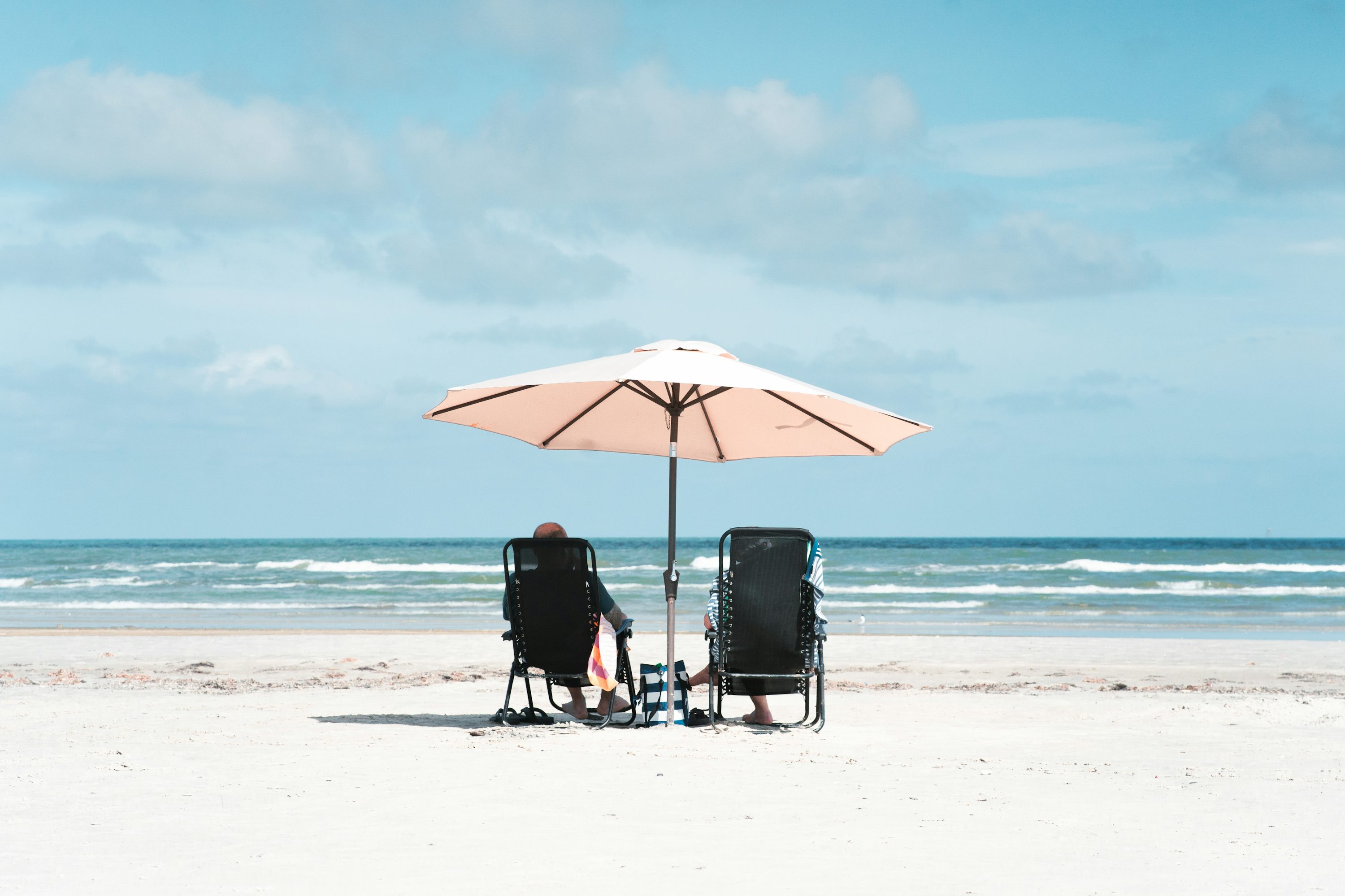 Peaceful beach chairs under umbrella on a secluded Gulf beach